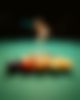 Woman is playing at a Billard table