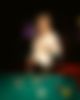 Woman is playing at a Billard table