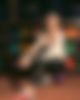 A woman is sitting at a bowling ball