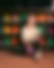A woman in front of bowling balls